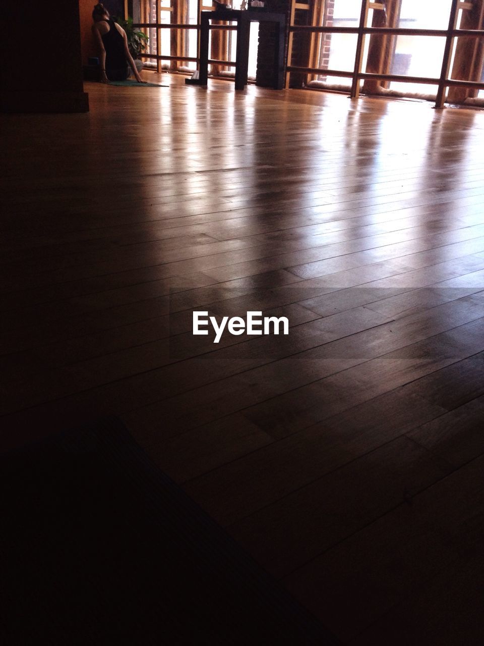 Rear view of woman practicing yoga in studio