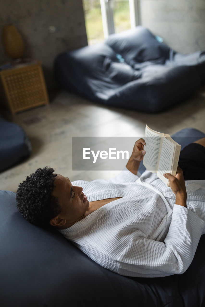 Man reading book in living room