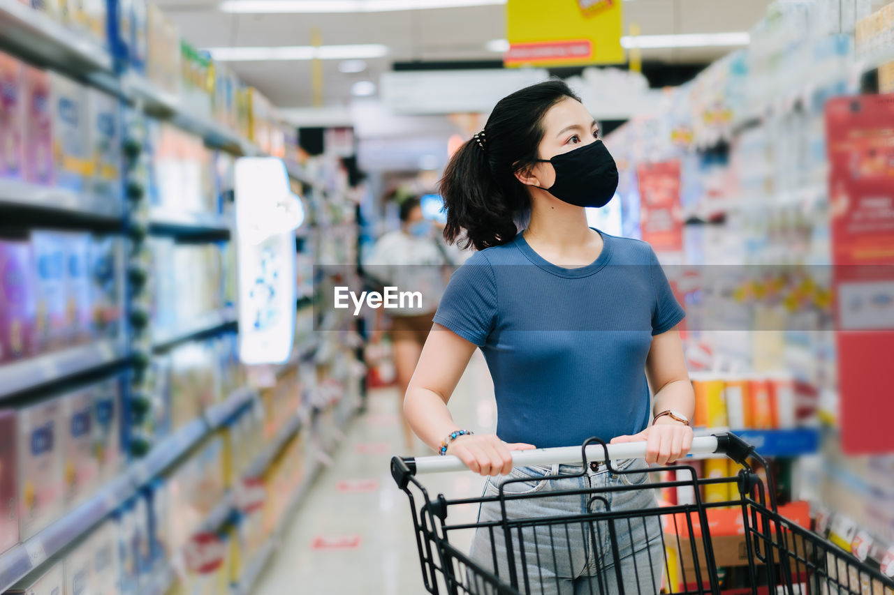 WOMAN STANDING IN STORE