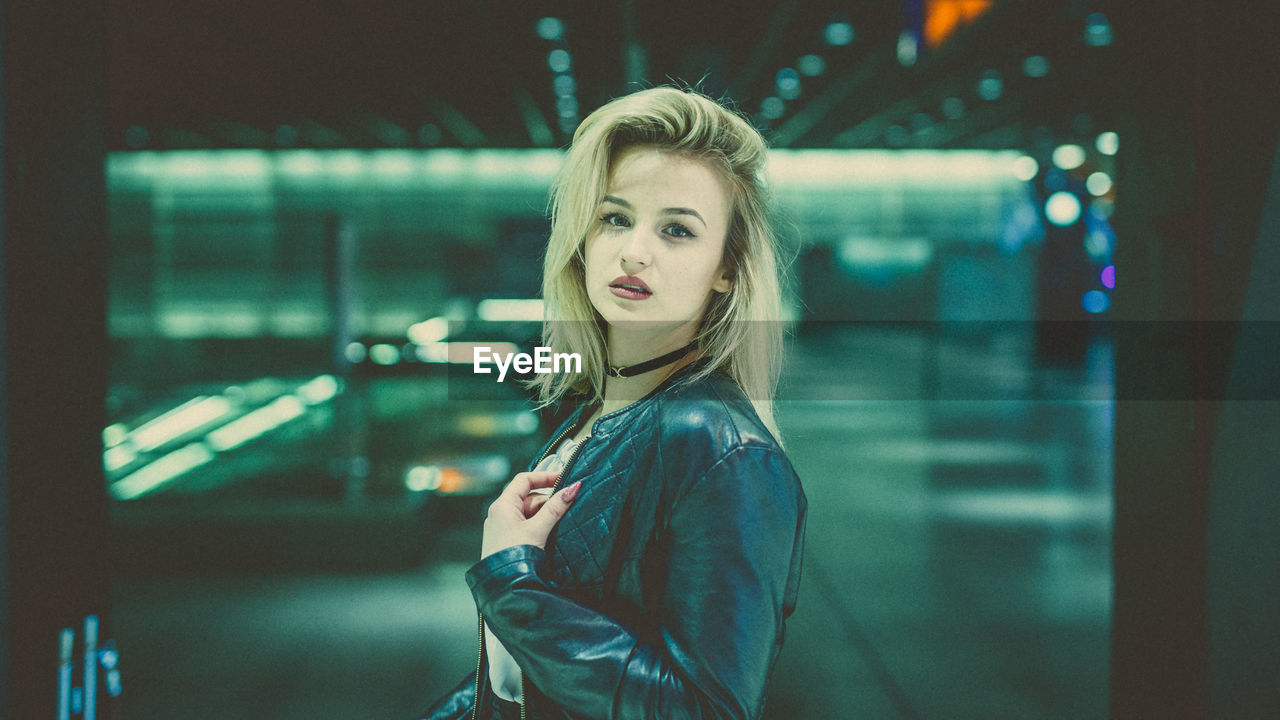 Portrait of young woman at railroad station