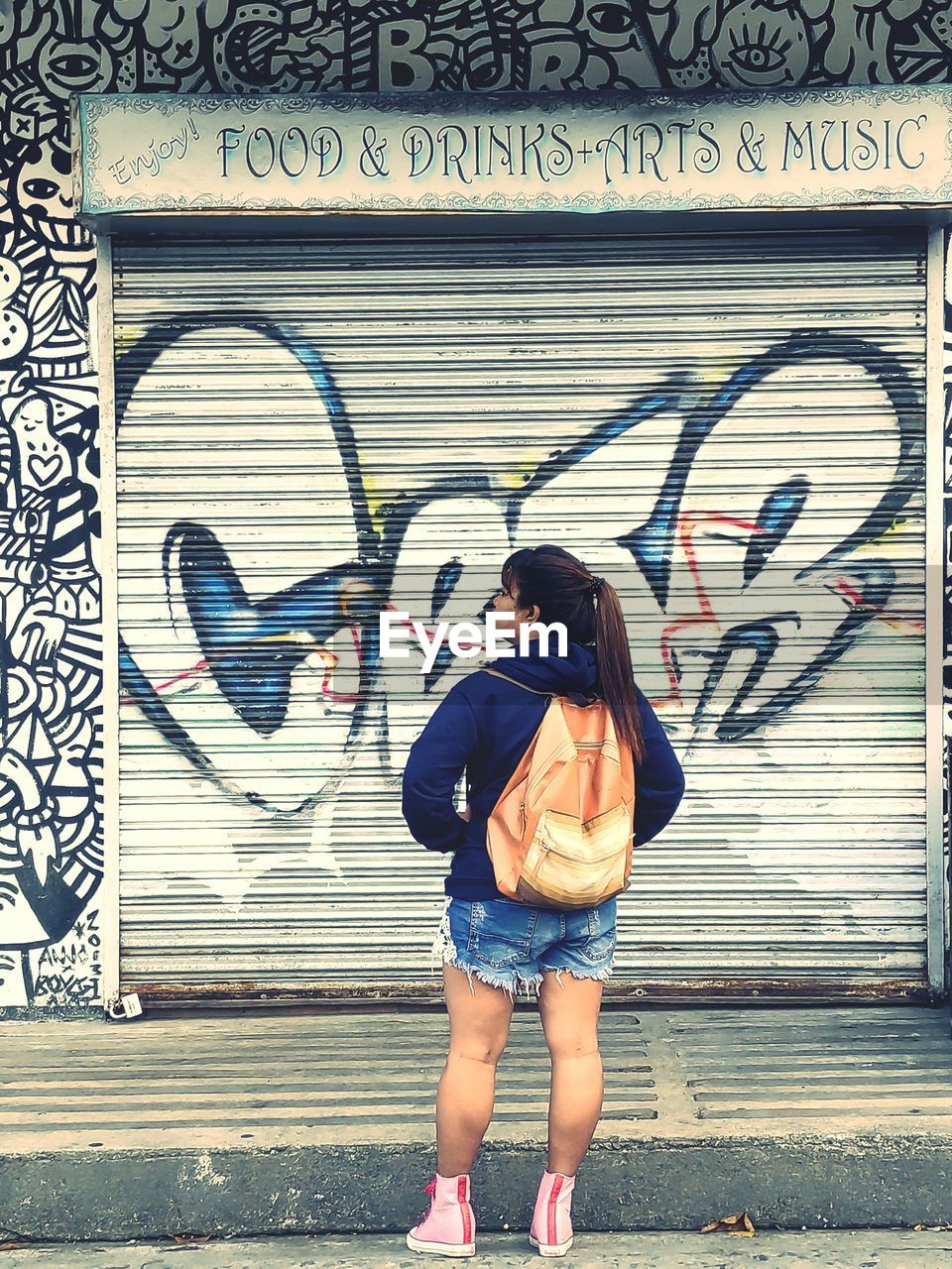 FULL LENGTH OF WOMAN STANDING ON WALL