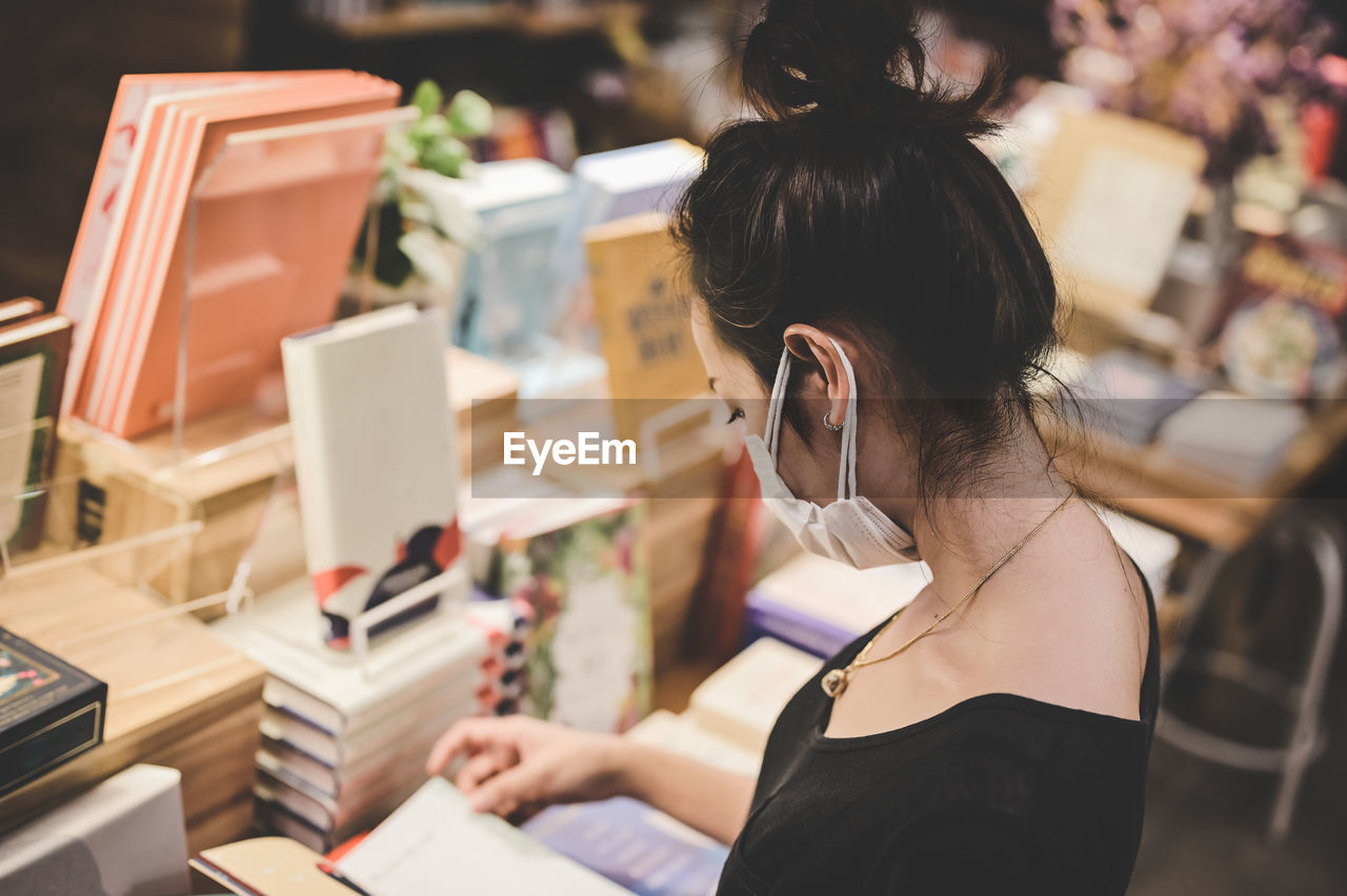 Series photo of young women choosing book in a bookshop , learning and education concept