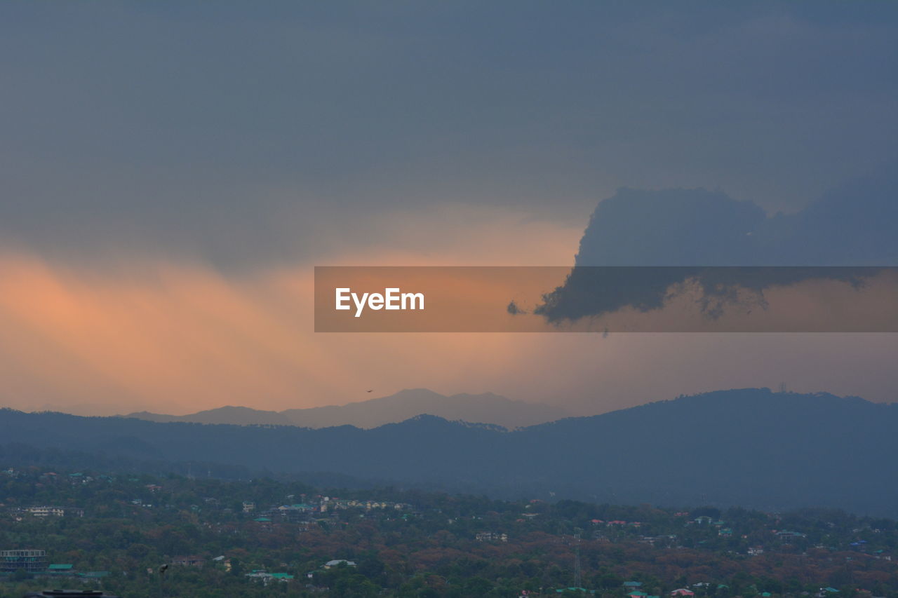SCENIC VIEW OF MOUNTAINS AGAINST ORANGE SKY
