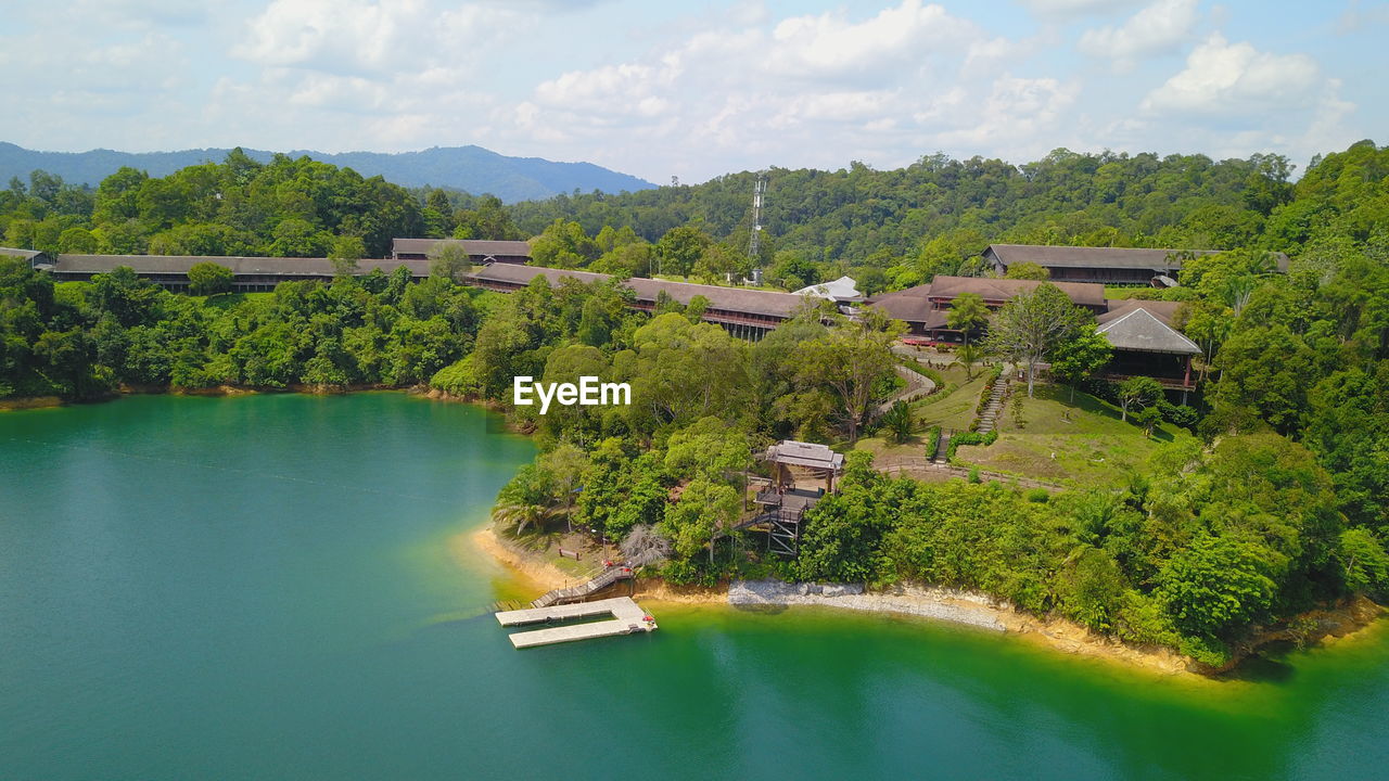 High angle view of river and trees against sky