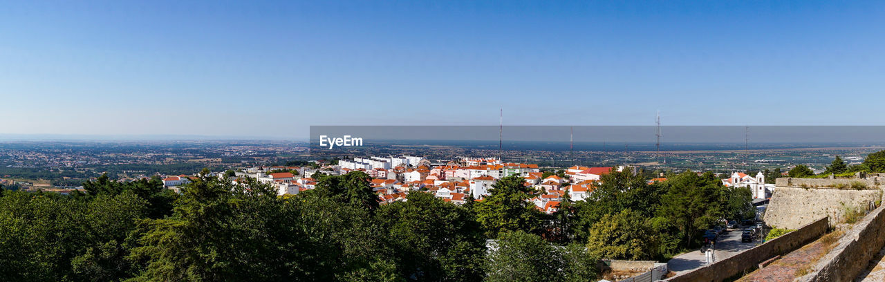 High angle view of townscape against clear blue sky