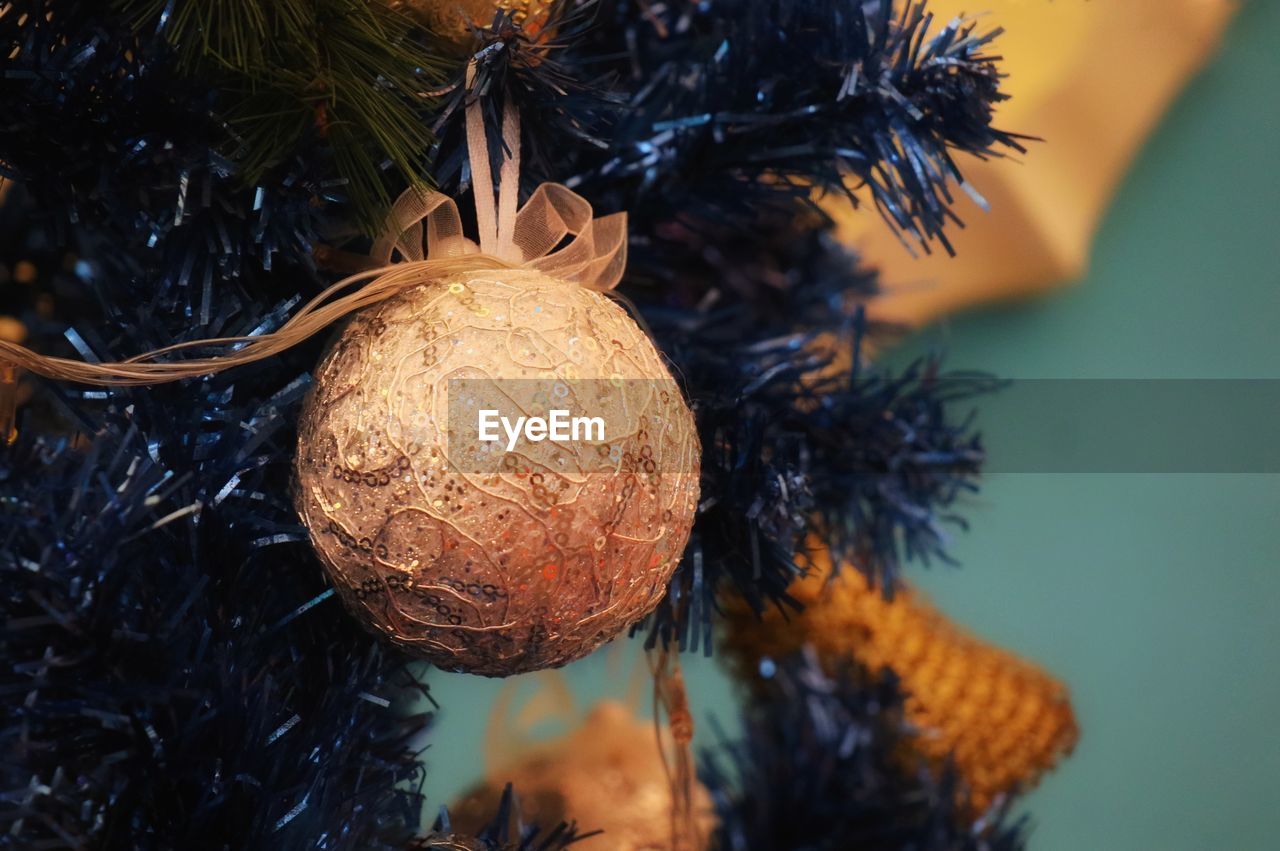 Golden ball in christmas fir tree with decoration. christmas and happy new year.