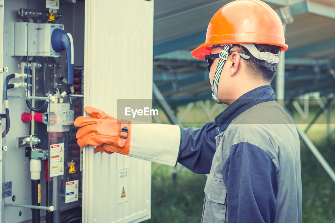 Manual worker examining machinery