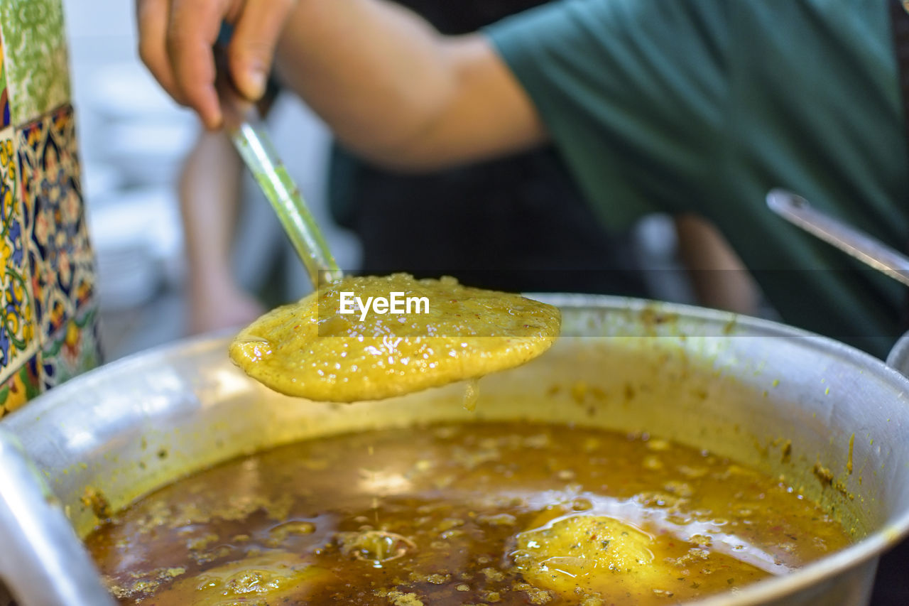 Close-up of hand holding ladle