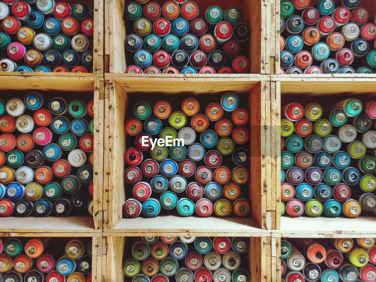 Full frame shot of colorful thread spools in wooden containers