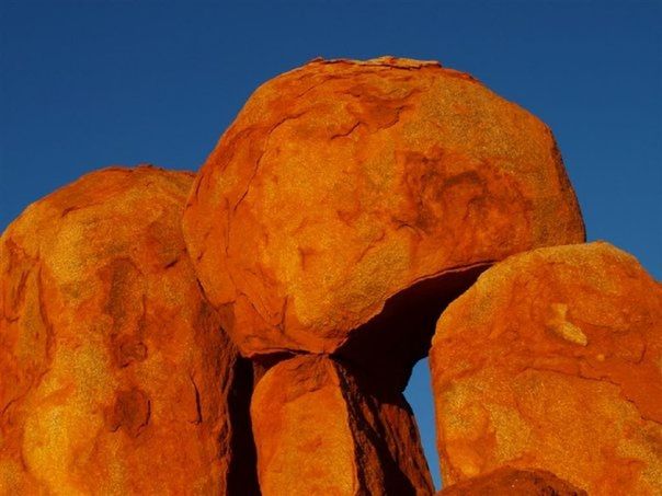 LOW ANGLE VIEW OF ROCKS AGAINST CLEAR BLUE SKY