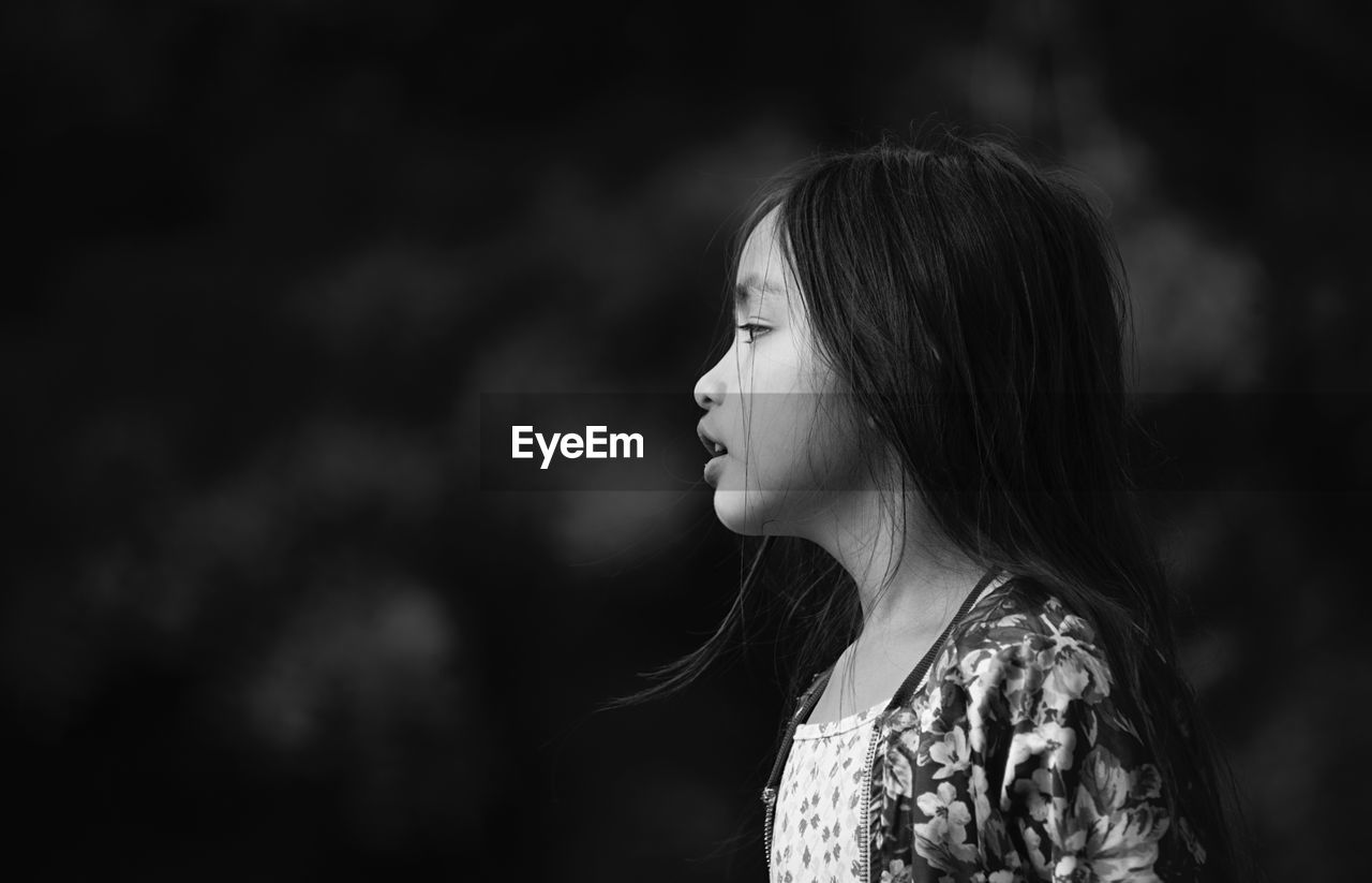 Close-up of girl looking away outdoors