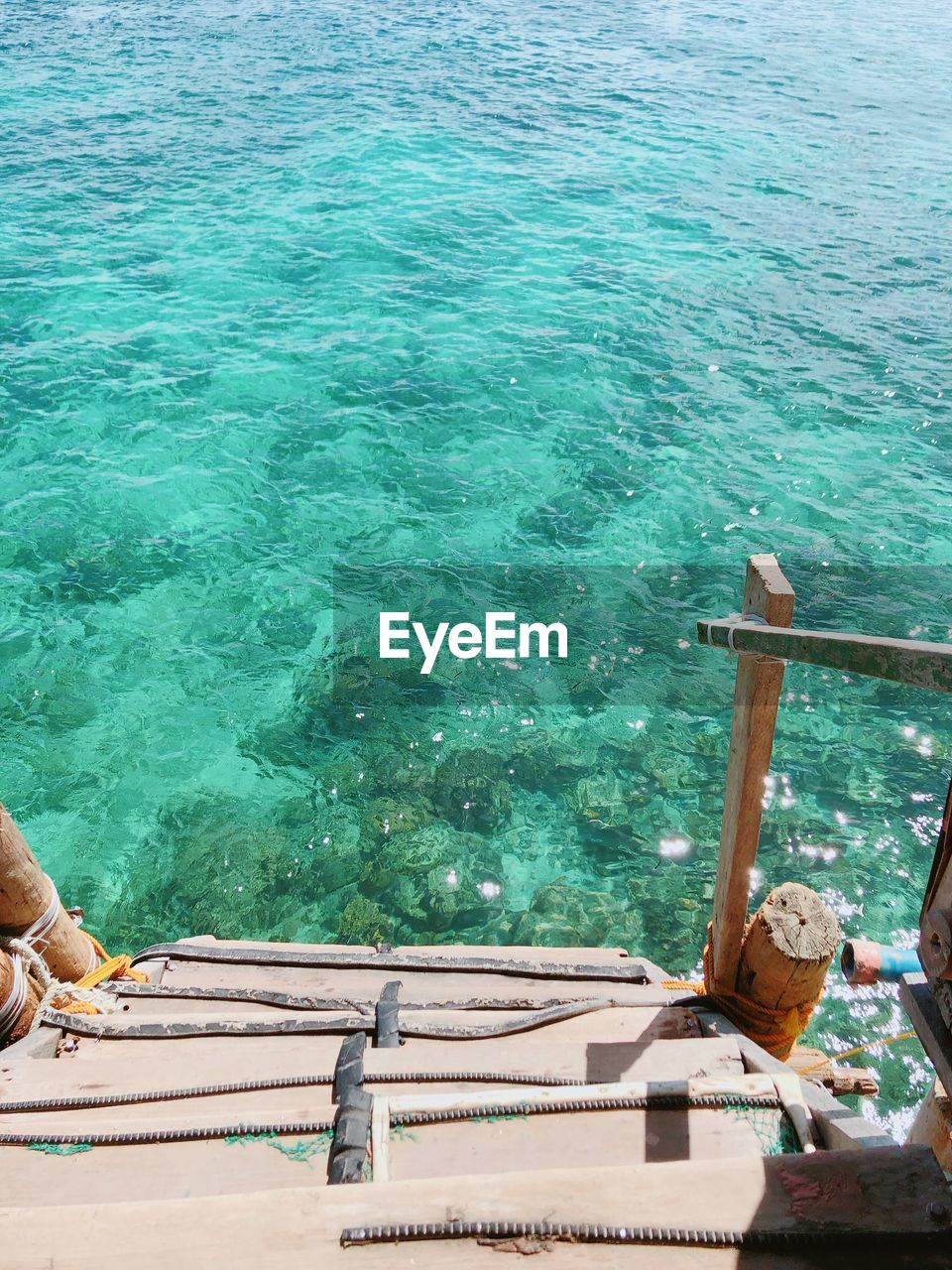 High angle view of steps to the beautiful emerald green sea.