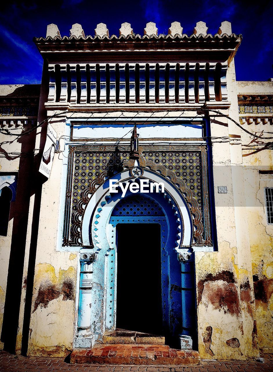 LOW ANGLE VIEW OF TEMPLE AGAINST BUILDING