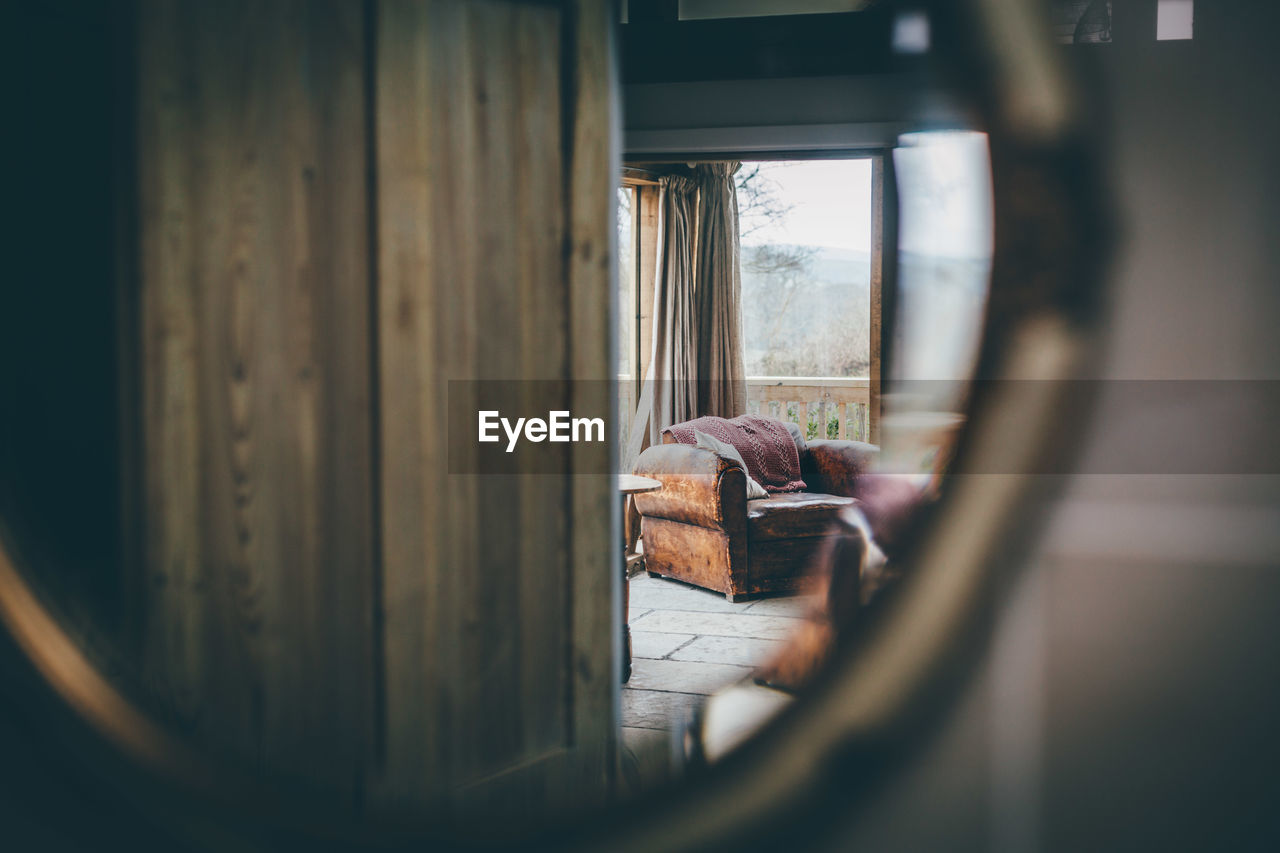 Reflection of sofa in mirror at home