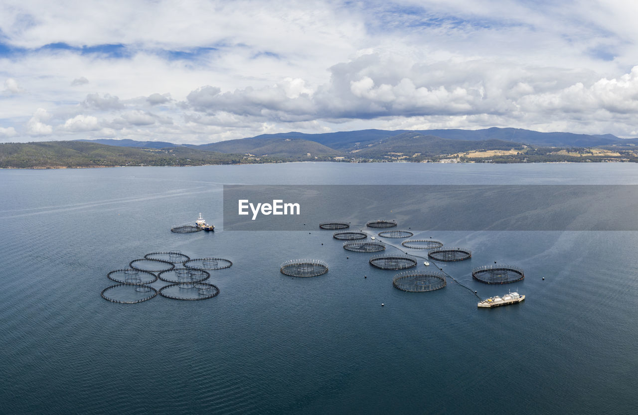 Aerial drone view of a large salmon fish farm  in the hobart region of tasmania, australia.