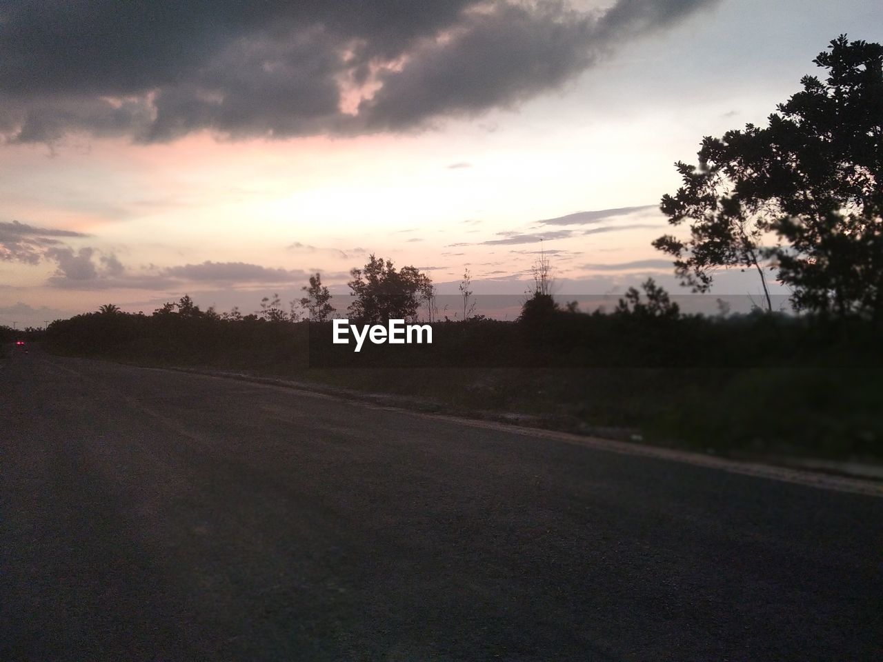 sky, cloud, tree, sunset, road, plant, landscape, transportation, environment, nature, scenics - nature, beauty in nature, no people, horizon, tranquility, land, dawn, tranquil scene, outdoors, non-urban scene, dramatic sky, rural scene, travel, evening, silhouette, the way forward, street