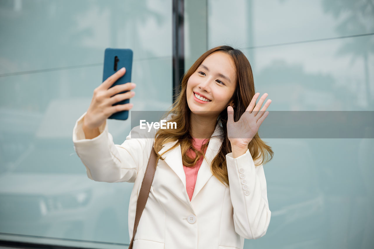 portrait of young woman using phone