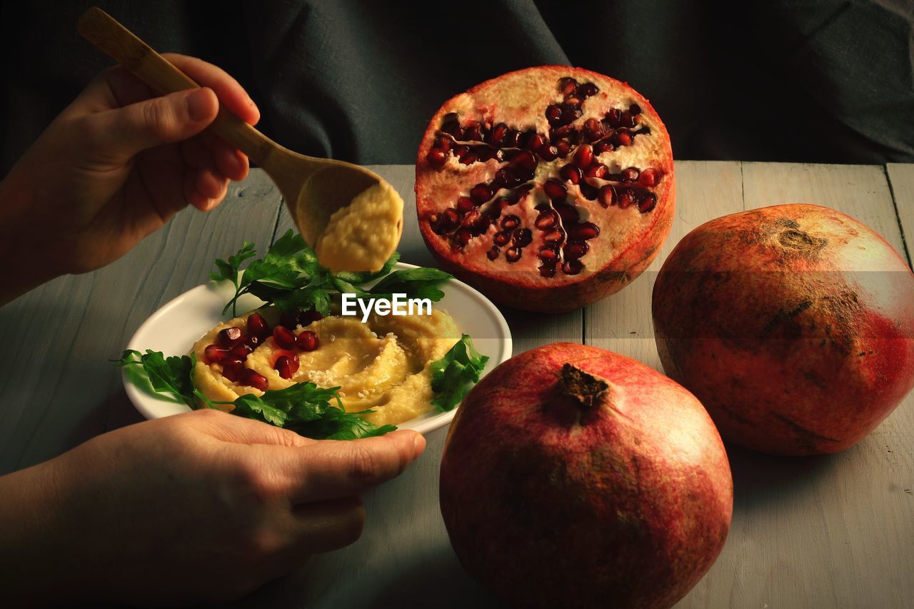 Close-up of hand holding food on table