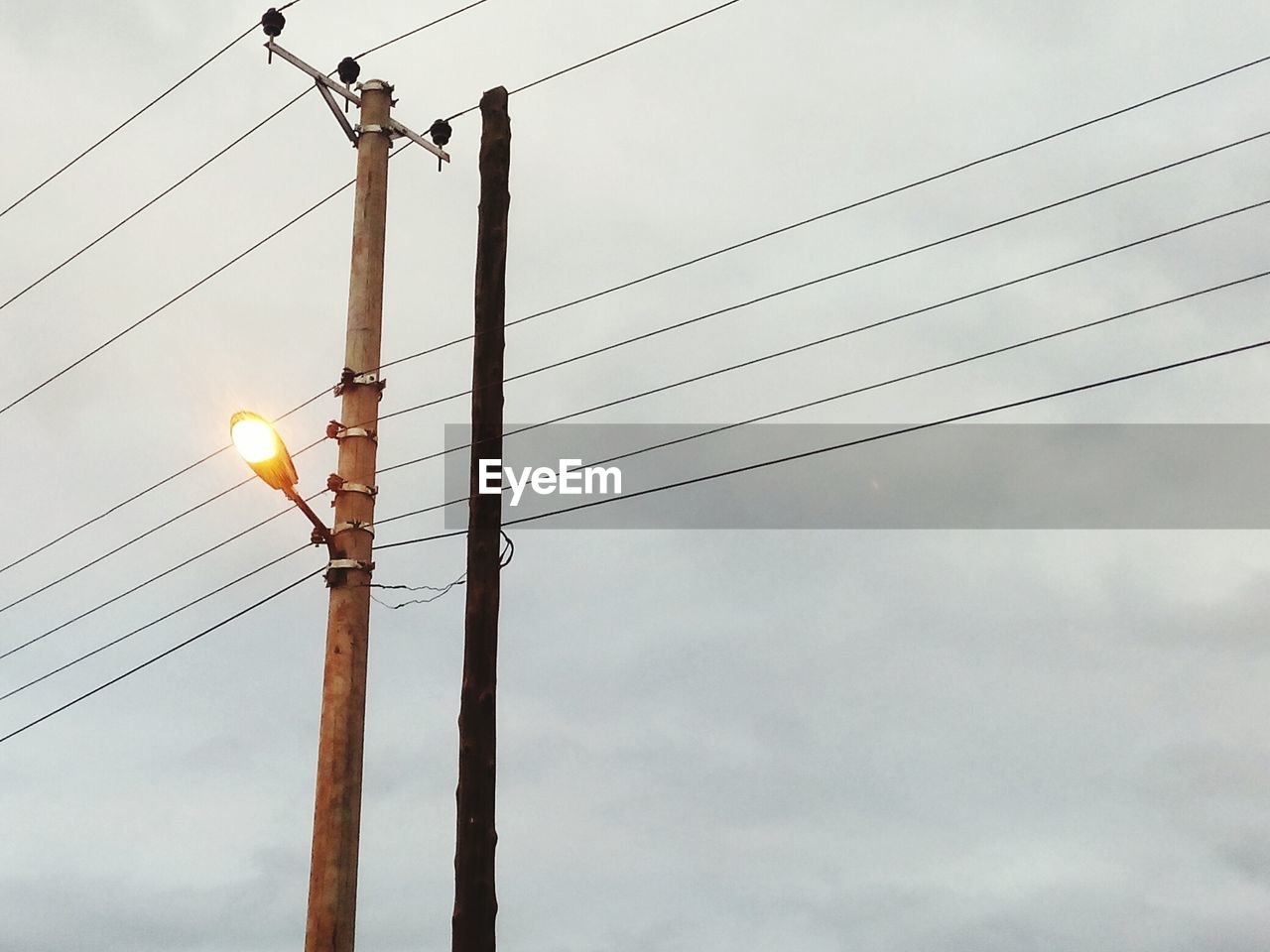 LOW ANGLE VIEW OF POWER LINES AGAINST SKY