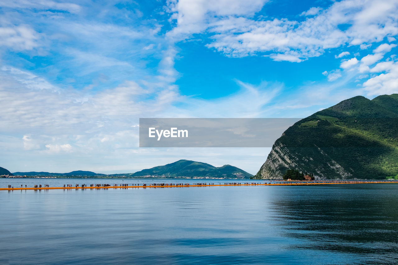 Scenic view of lake iseo against blue sky