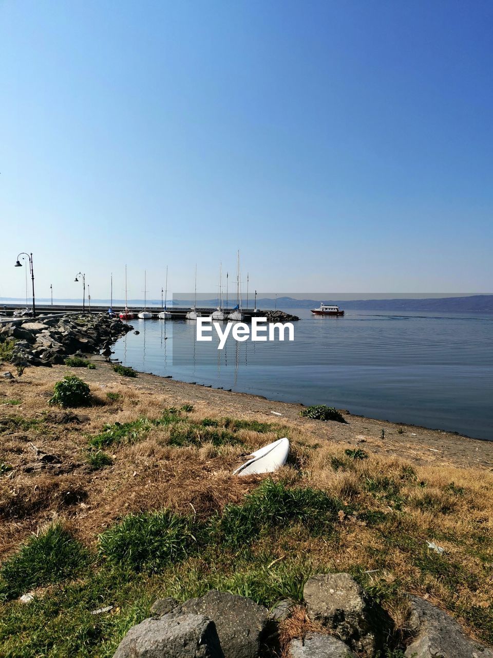 Scenic view of sea against clear blue sky