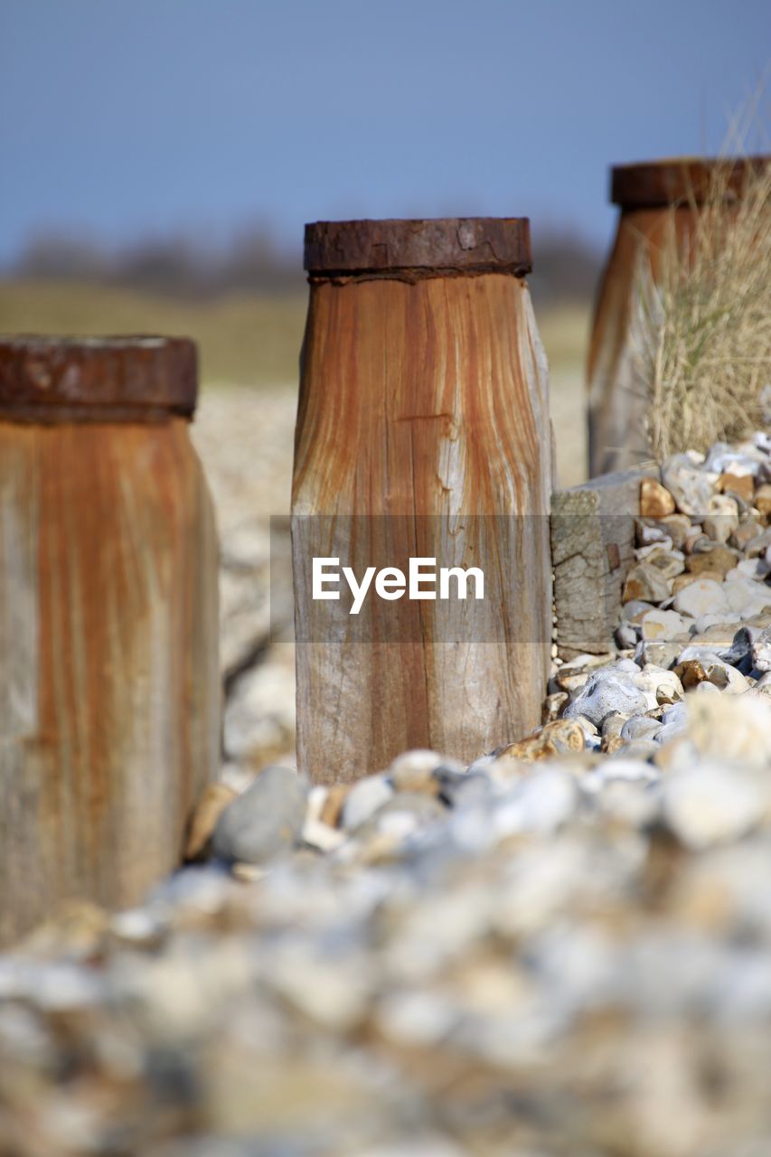 Close-up of weathered groyne posts at beach