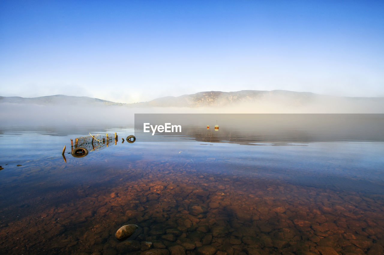 Scenic view of lake against blue sky