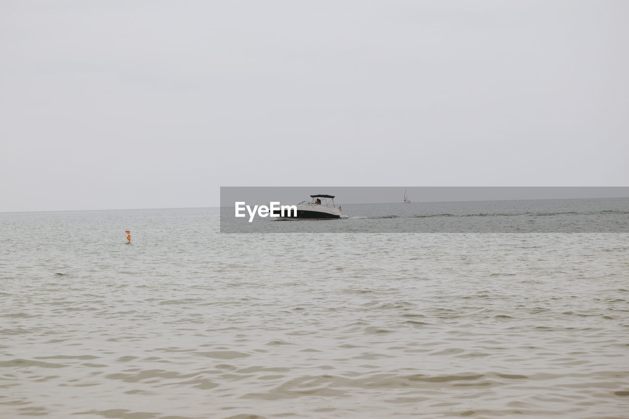 Boat on sea against clear sky