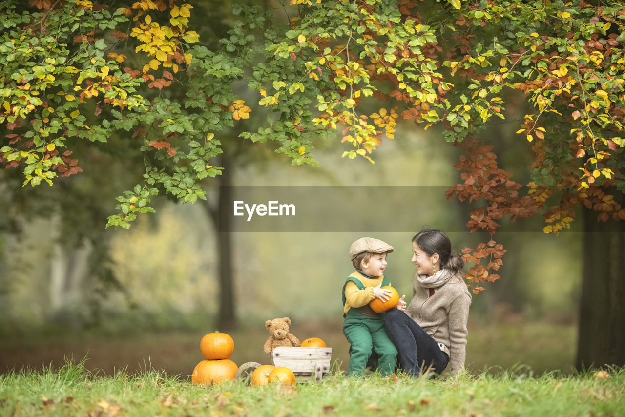 Mother and son on field during autumn