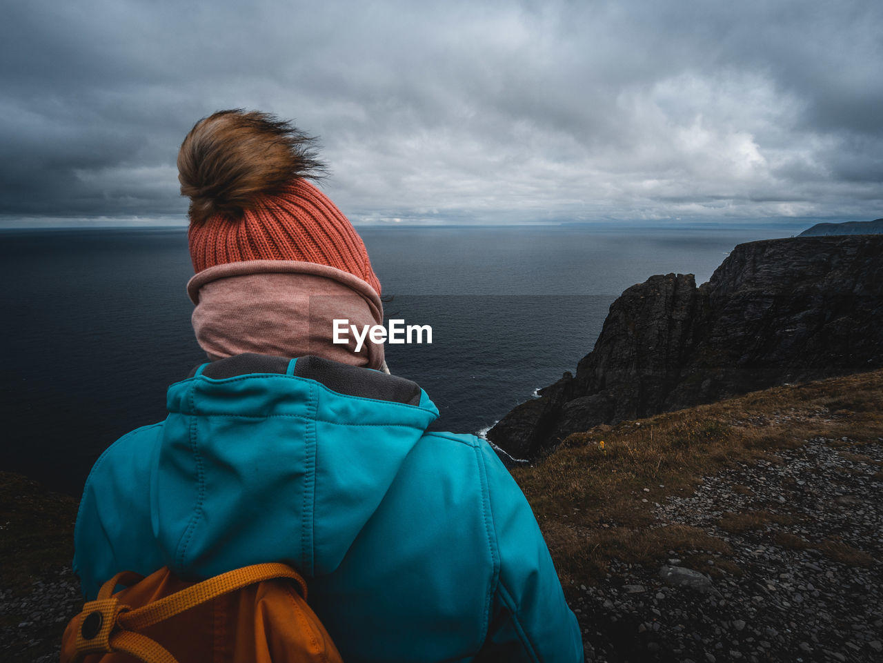 Rear view of person standing against sea