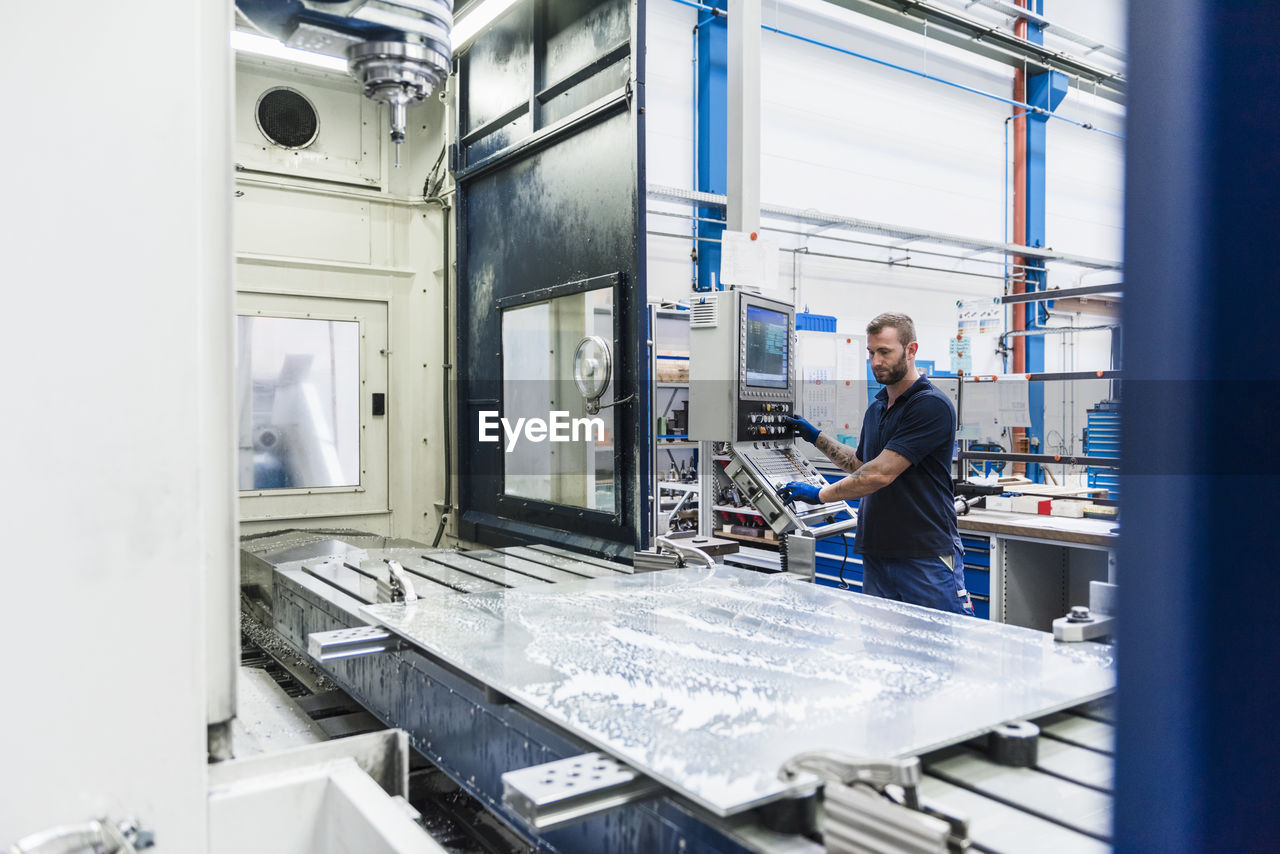 Man operating machine in industrial factory