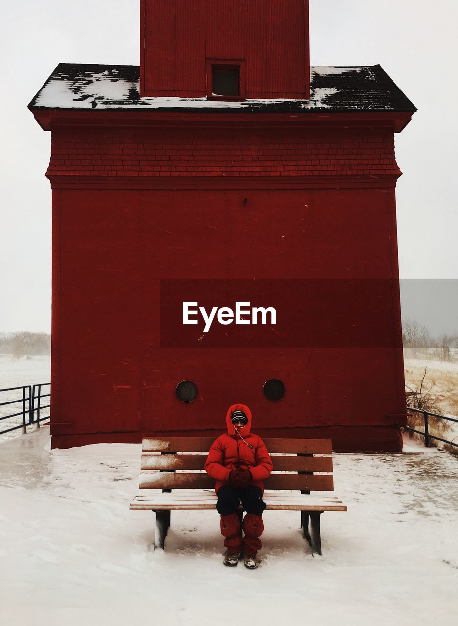 Person sitting on bench during winter