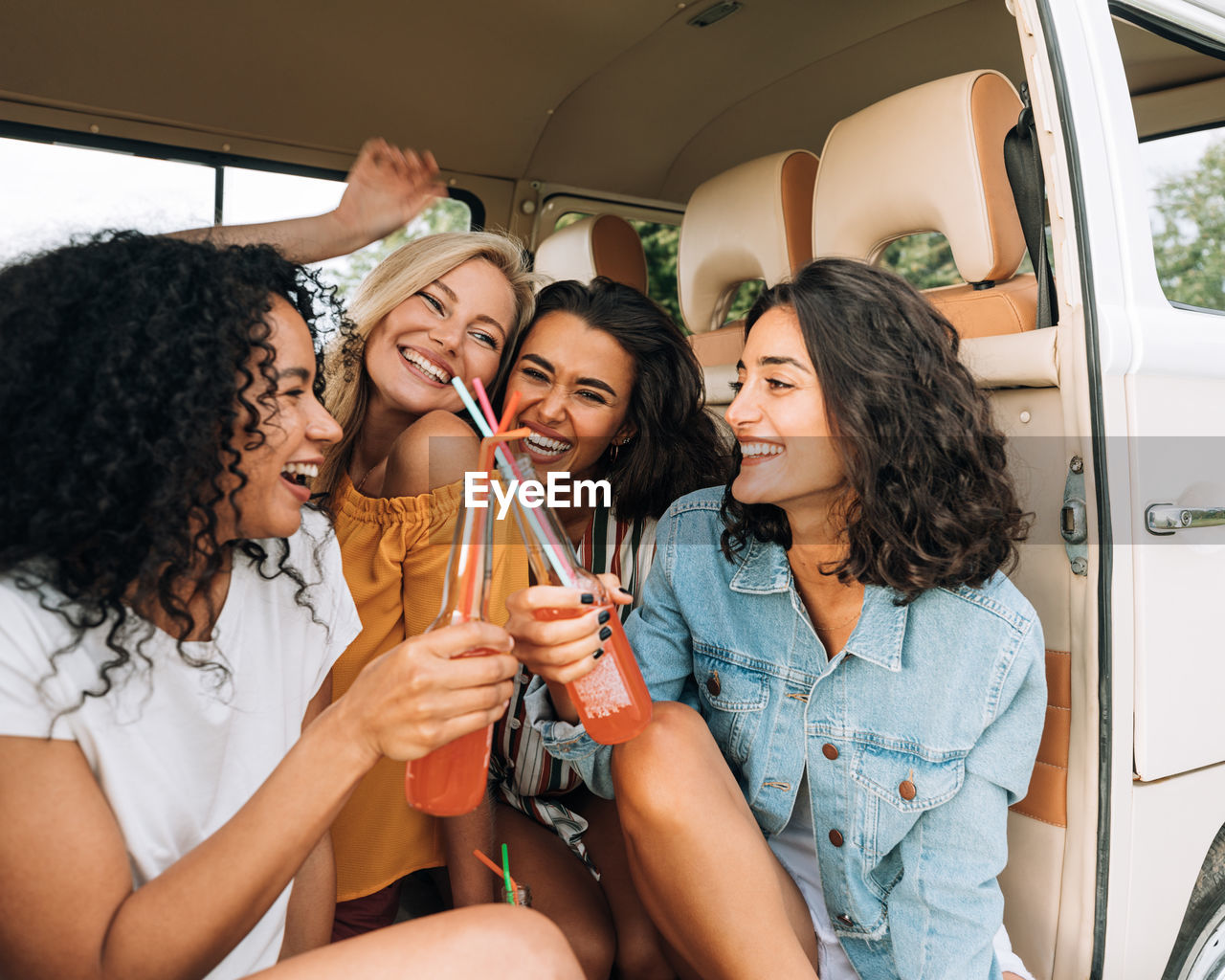 Happy young woman sitting in bus