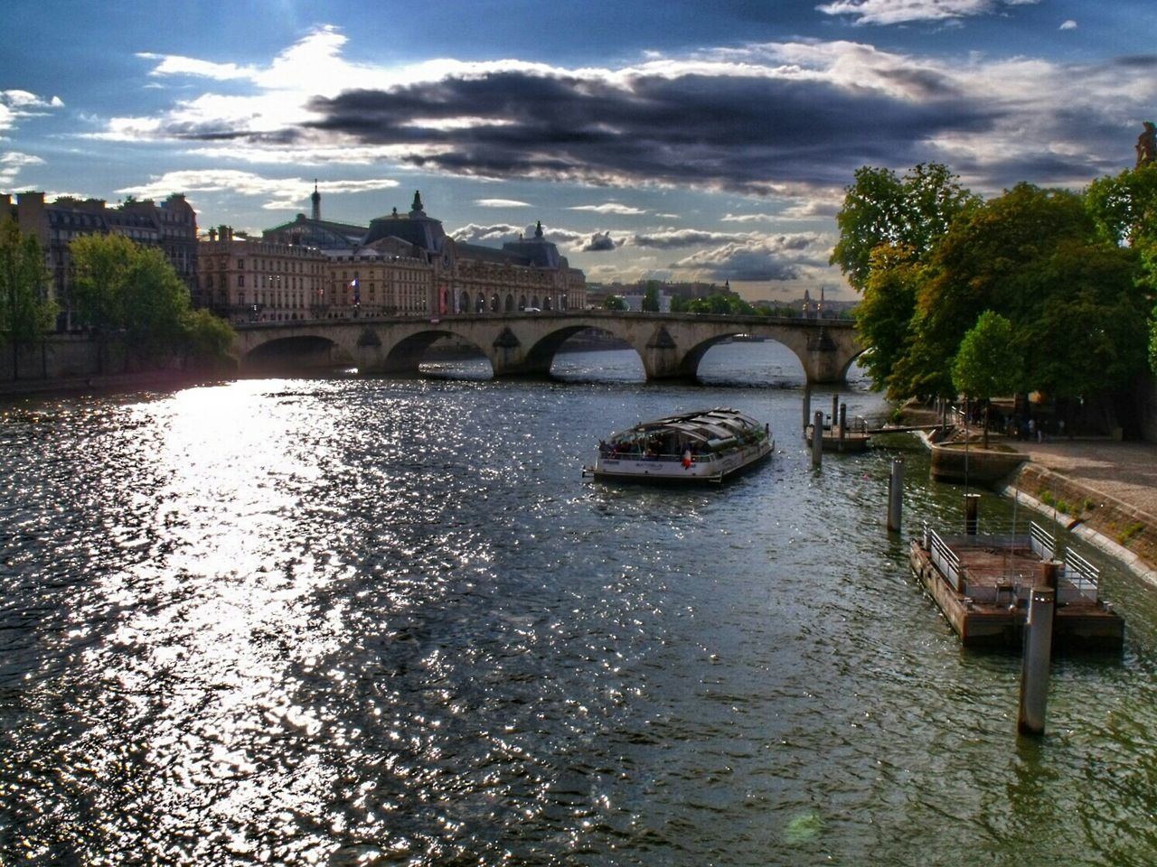 Ferry in river by buildings