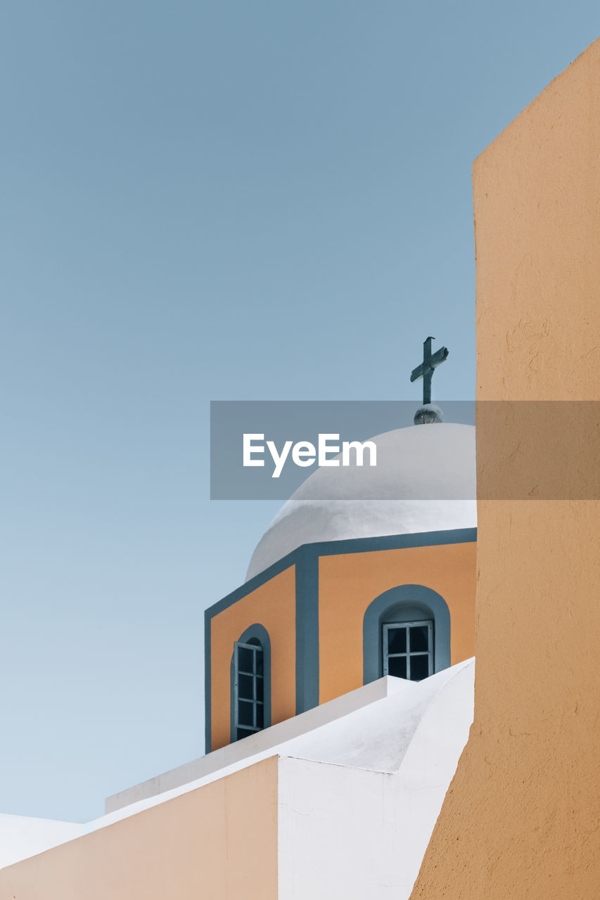 Low angle view of church against clear blue sky in santorini , greece
