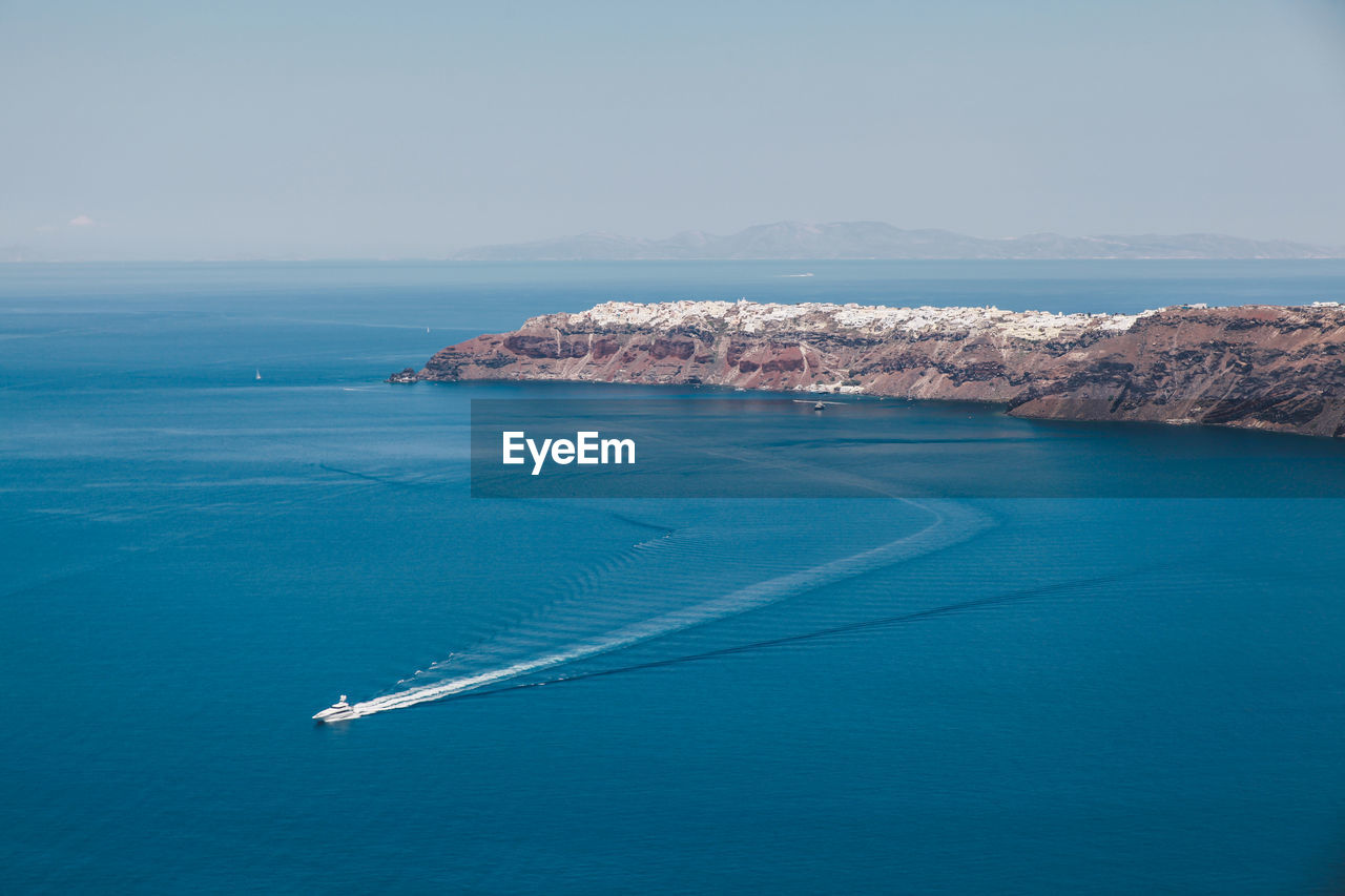 Boat sailing in sea against sky