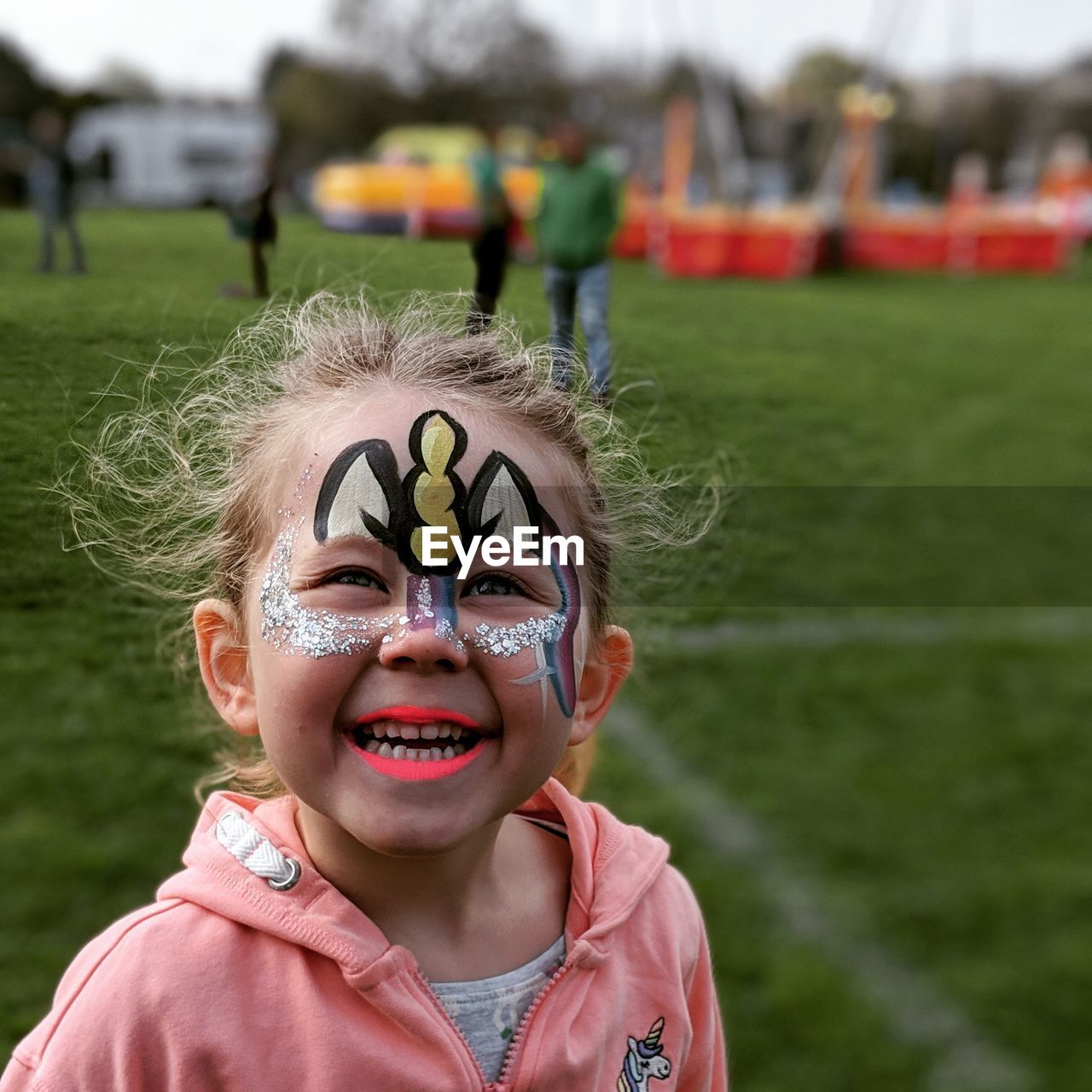 Portrait of smiling girl with painted face during event