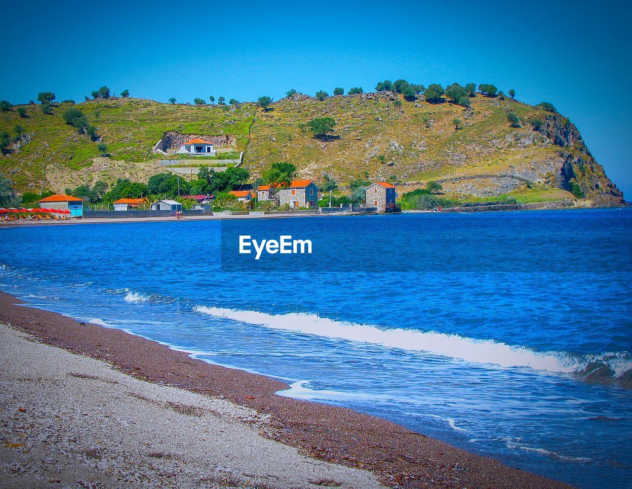 Scenic view of sea by mountain