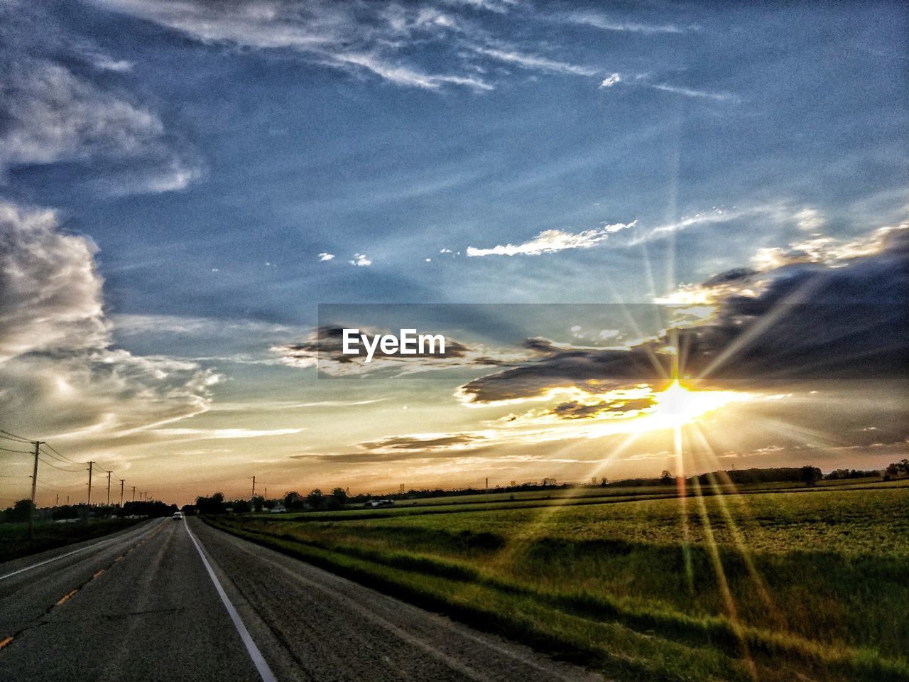 ROAD AGAINST SKY AT SUNSET