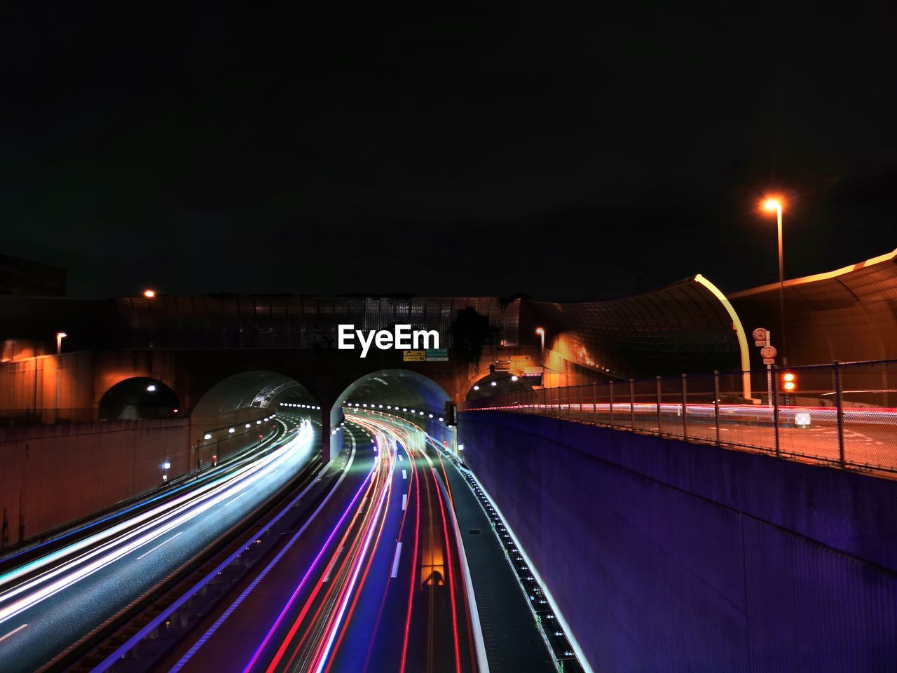night, light trail, illuminated, long exposure, transportation, architecture, motion, speed, city, built structure, light, road, traffic, street, blurred motion, tail light, building exterior, mode of transportation, darkness, highway, street light, city life, bridge, lighting equipment, evening, travel destinations, headlight, travel, no people, motor vehicle, sky, light - natural phenomenon, nature, car, on the move, city street, outdoors, cityscape, vehicle light, multi colored, dusk, multiple lane highway