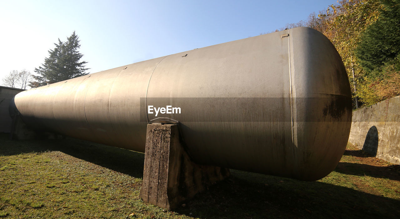 VIEW OF PIPES AGAINST CLEAR SKY