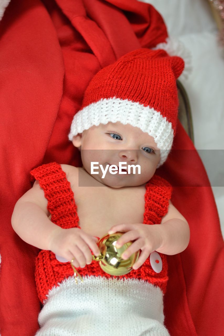 Portrait of a newborn baby in christmas clothes and santa hat
