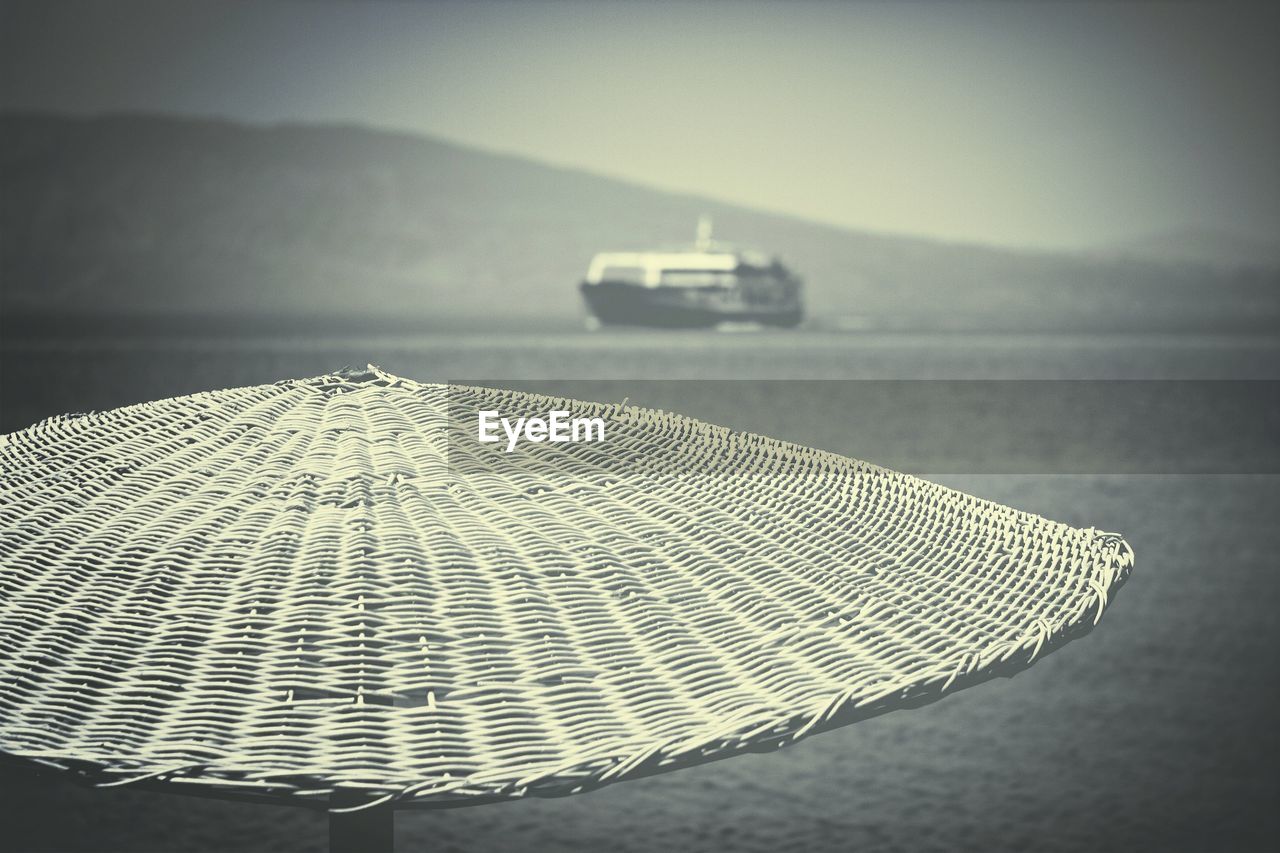 Close-up of wicker sunshade against blurred background