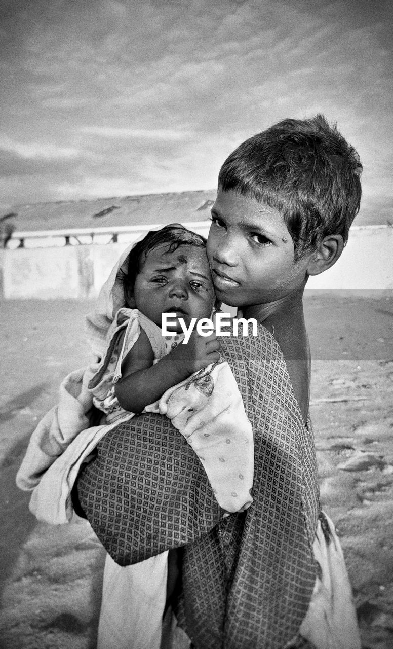 child, black and white, childhood, men, two people, togetherness, family, person, beach, emotion, white, land, monochrome, monochrome photography, adult, love, bonding, black, positive emotion, female, women, toddler, nature, sky, parent, happiness, smiling, portrait, sea, leisure activity, one parent, carrying, day, baby, casual clothing, lifestyles, portrait photography, standing, water, sand, embracing, waist up, holding, romance, human face, clothing, outdoors, cloud