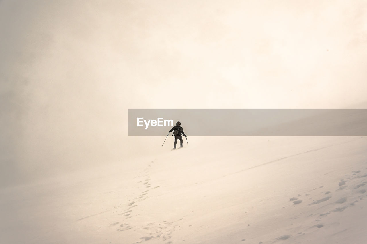 A person walking in snowy mountains