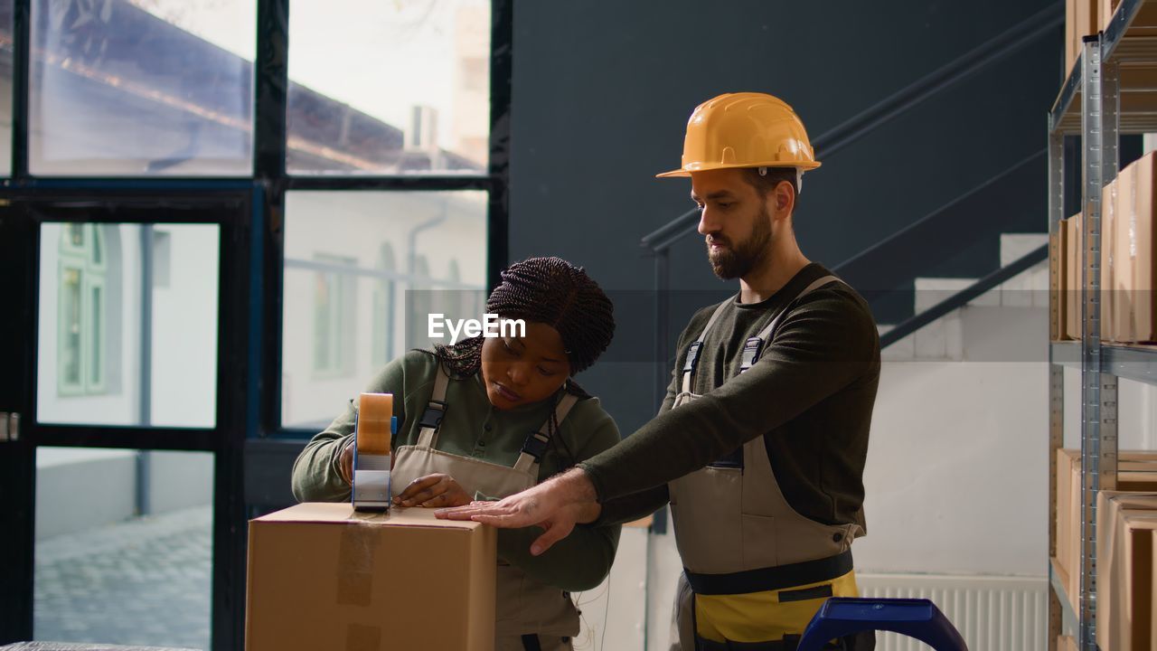 side view of young man working in factory