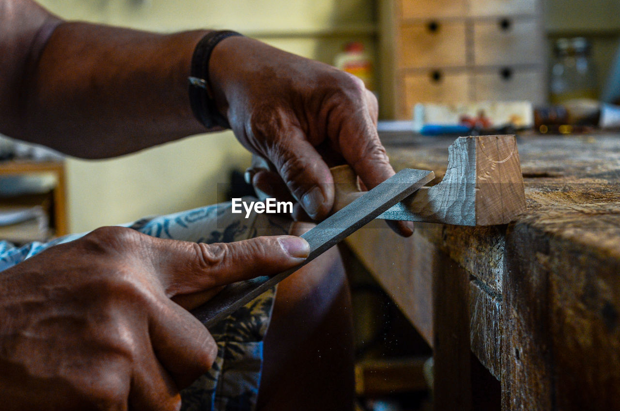 Violin maker luthier hand working a new violin scroll in cremona italy