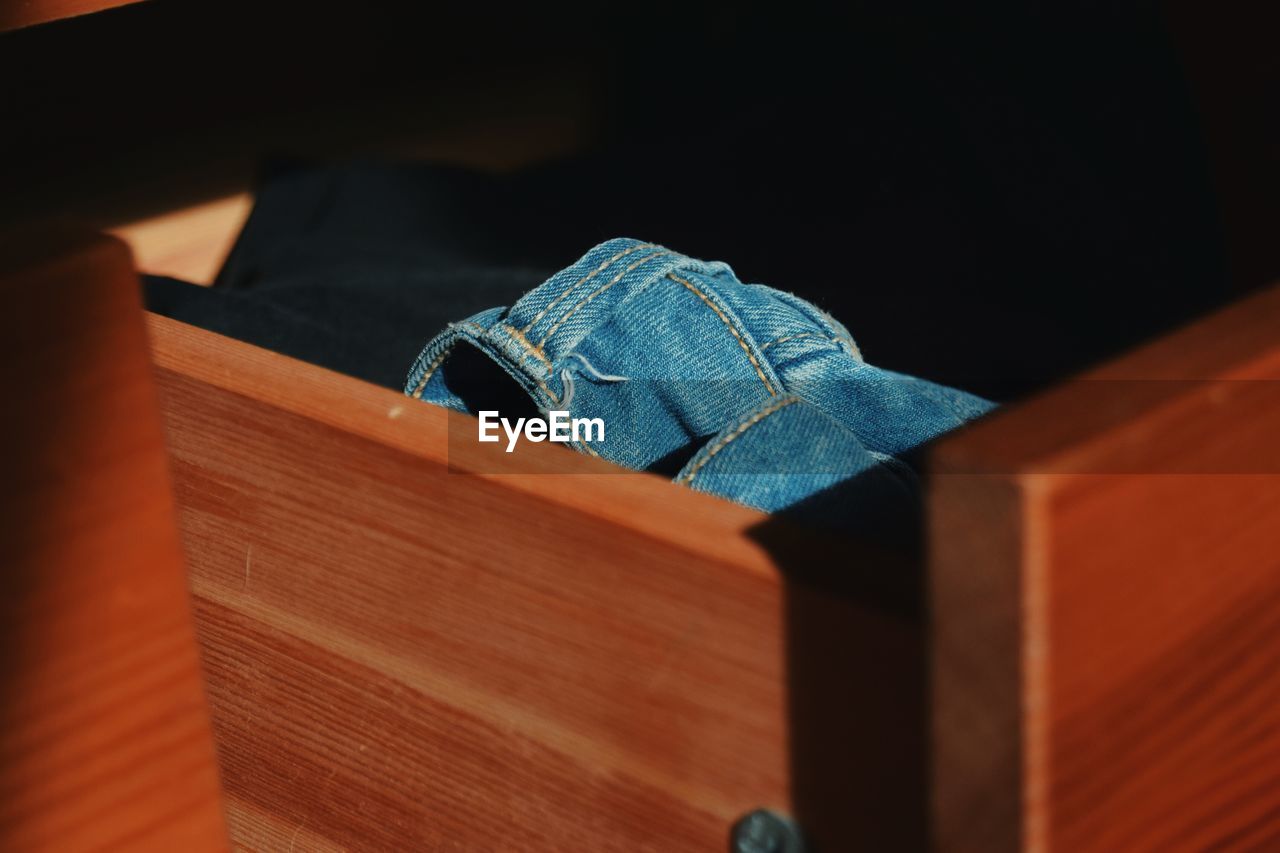 High angle view of jeans in drawer