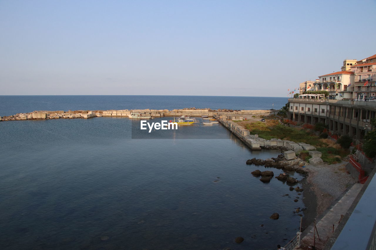 water, sea, sky, architecture, coast, built structure, building exterior, clear sky, nature, shore, travel destinations, land, body of water, vacation, beach, ocean, travel, horizon over water, building, horizon, city, bay, tourism, scenics - nature, blue, beauty in nature, no people, trip, outdoors, holiday, day, tranquility, copy space, history, nautical vessel, reflection, transportation, coastline, sunny, the past, tranquil scene, residential district, house, terrain