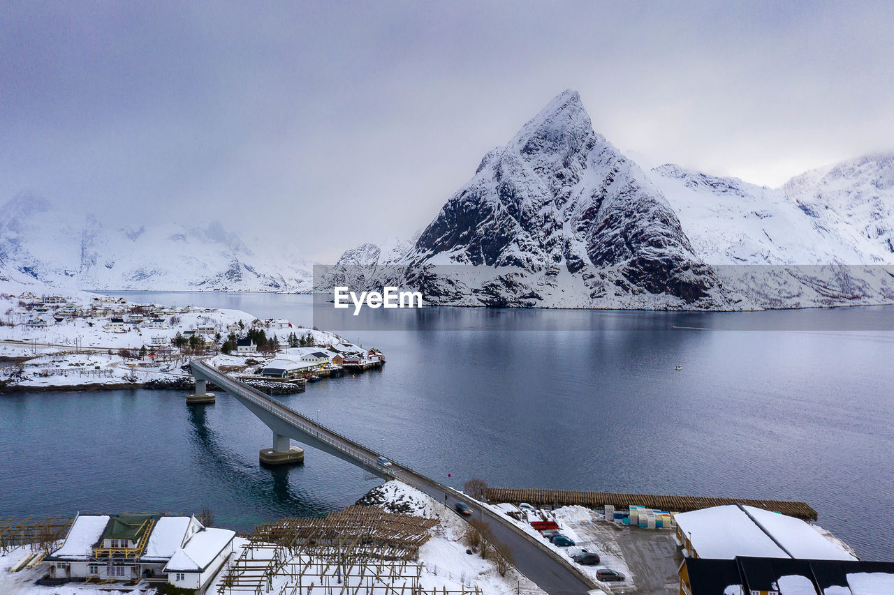 Scenic view of snowcapped mountains by lake against sky